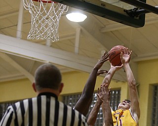 Anthony Fire(11) of Cardinal Mooney goes up to try to get the ball into the basket during the 1st quarter as Cardinal Mooney takes on Ursuline, Friday, March 3, 2017 at Ursuline High School. Ursuline won 39-37...(Nikos Frazier | The Vindicator)..
