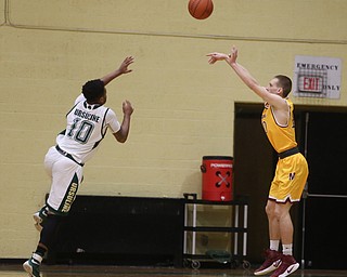 Pat Pelini(10) of Cardinal Mooney goes up for three as Dwaylin Washington(10) of Ursuline tries to block his shot during the 1st quarter as Cardinal Mooney takes on Ursuline, Friday, March 3, 2017 at Ursuline High School. Ursuline won 39-37...(Nikos Frazier | The Vindicator)..