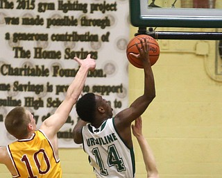 Dakota Hobbs(14) of Ursuline goes up for two as Pat Pelini(10) of Cardinal Mooney tries to block his shot during the 2nd quarter as Cardinal Mooney takes on Ursuline, Friday, March 3, 2017 at Ursuline High School. Ursuline won 39-37...(Nikos Frazier | The Vindicator)..
