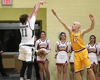 (11) of Ursuline goes up for three as Johnnie Mikos(12) tries to block his shot during the 2nd quarter as Cardinal Mooney takes on Ursuline, Friday, March 3, 2017 at Ursuline High School. Ursuline won 39-37...(Nikos Frazier | The Vindicator)..