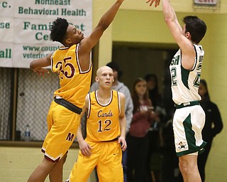 Vince Venzio(22) of Ursuline goes up for three as Jordan Stanford(35) of Cardinal Mooney tries to block his shot during the 2nd quarter as Cardinal Mooney takes on Ursuline, Friday, March 3, 2017 at Ursuline High School. Ursuline won 39-37...(Nikos Frazier | The Vindicator)..