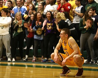 Pat Pelini(10) of Cardinal Mooney rests in between plays as the Ursuline Student Section celebrates in the background during the 2nd quarter as Cardinal Mooney takes on Ursuline, Friday, March 3, 2017 at Ursuline High School. Ursuline won 39-37...(Nikos Frazier | The Vindicator)..