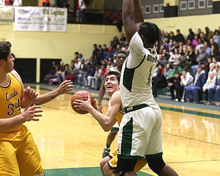 Anthony Fire(11) of Cardinal Mooney is boxed out from the basket by Anthony Howell(1) of Ursuline during the 2nd quarter as Cardinal Mooney takes on Ursuline, Friday, March 3, 2017 at Ursuline High School. Ursuline won 39-37...(Nikos Frazier | The Vindicator)..