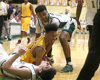 Jordan Stanford(35) of Cardinal Mooney and Dwaylin Washington(10) of Ursuline look towards the referee for the call as they fight for a loose ball during the 3rd quarter as Cardinal Mooney takes on Ursuline, Friday, March 3, 2017 at Ursuline High School. Ursuline won 39-37...(Nikos Frazier | The Vindicator)..