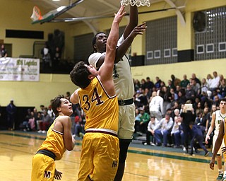 Anthony Howell(1) goes up for two during the 3rd quarter as Cardinal Mooney takes on Ursuline, Friday, March 3, 2017 at Ursuline High School. Ursuline won 39-37...(Nikos Frazier | The Vindicator)..