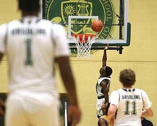 Dakota Hobbs(14) of Ursuline goes up for a layup after a breakaway steal during the 4th quarter as Cardinal Mooney takes on Ursuline, Friday, March 3, 2017 at Ursuline High School. Ursuline won 39-37...(Nikos Frazier | The Vindicator)..