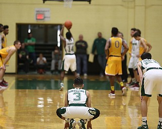 Anise Algahmere(3) and Vince Venzio(22) of Ursuline watch  as Dakota Hobbs(14) takes two foul shots to tie the fame late in the 4th quarter as Cardinal Mooney takes on Ursuline, Friday, March 3, 2017 at Ursuline High School. Ursuline won 39-37...(Nikos Frazier | The Vindicator)..