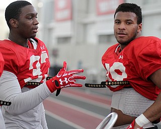 William D Lewis the Vindicator YSU DE's Johnson Loigene)(33), left, and Fazson Chapman(98) talk during 3-3-17 practice at WATTS Center.