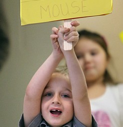 Kindergartner Alex Waddell holds up his Mickey sign.