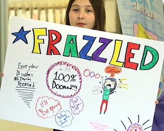 Fourth-grader Gianna Miller with and her poster.