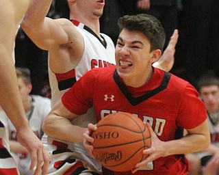 William D. Lewis The Vinidcator Girard's Austin O'Hara(33) drives around Canfield's Jake Cummings during 3-3-17 action at Canfield.