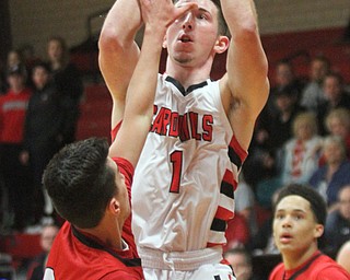 William D. Lewis The Vindicator  Canfield's Jake Cumming's (1) shoots over Girard's Austin Clausell(2) during 3-3-17 action in Canfield.