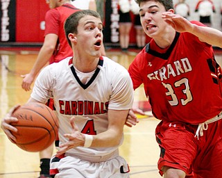 William D. Lewis The Vindicator Canfield's Brandon McFall (4) and Girard's Austin O'Hara (33) during 3-3-17 action at Canfield.