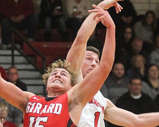 William D Lewis The inicator  Girard'sMark Waid (15) and Canfield's Jake Cummings(1) go for a rebound during 3-3-17 action at Canfield.