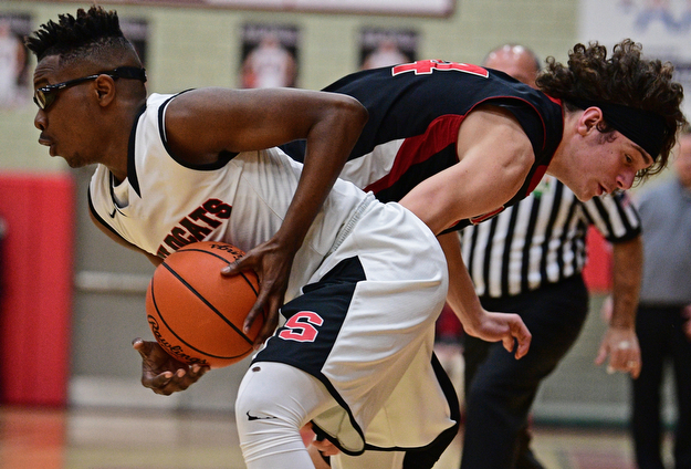 STRUTHERS, OHIO - MARCH 3, 2017: Kevin Traylor #3 of Struthers protects the ball from the steal attempt of Chase Ackerman #24 of Salem during the first half of their game Friday night at Struthers High School. DAVID DERMER | THE VINDICATOR
