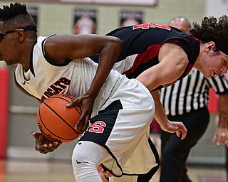 STRUTHERS, OHIO - MARCH 3, 2017: Kevin Traylor #3 of Struthers protects the ball from the steal attempt of Chase Ackerman #24 of Salem during the first half of their game Friday night at Struthers High School. DAVID DERMER | THE VINDICATOR
