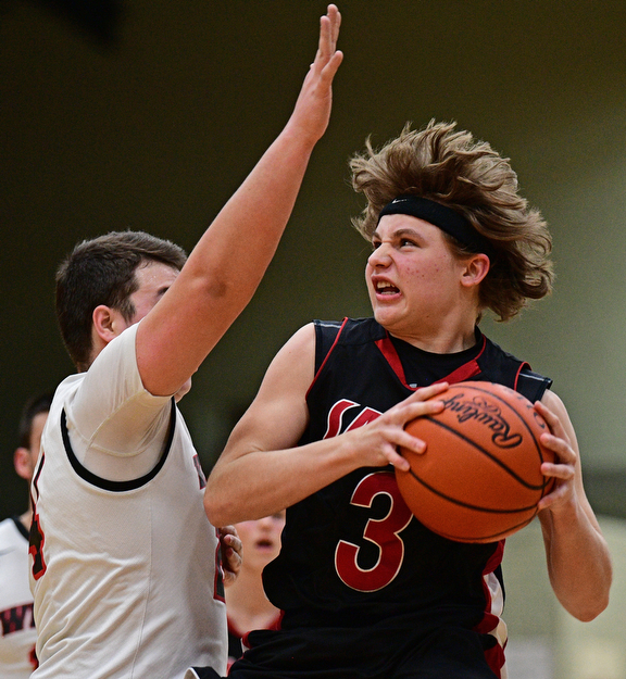 STRUTHERS, OHIO - MARCH 3, 2017: Josh Young #3 of Salem muscles his way to the basket while being guarded by Jaret Jacubec #24 of Struthers during the second half of their game Friday night at Struthers High School. DAVID DERMER | THE VINDICATOR