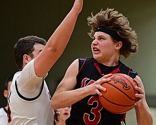 STRUTHERS, OHIO - MARCH 3, 2017: Josh Young #3 of Salem muscles his way to the basket while being guarded by Jaret Jacubec #24 of Struthers during the second half of their game Friday night at Struthers High School. DAVID DERMER | THE VINDICATOR