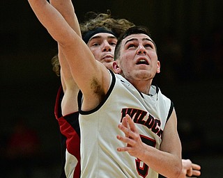 STRUTHERS, OHIO - MARCH 3, 2017: Andrew Carbon #5 of Struthers goes to the basket while being pressured from behind by Chase Ackerman #24 of Salem during the second half of their game Friday night at Struthers High School. DAVID DERMER | THE VINDICATOR