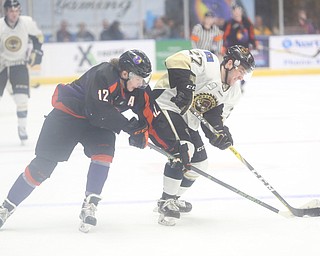 Lumberjacks Anthony Del Gaizo(27) and Phantoms Austin Pooley(12) fight for the puck during the 1st period as the Muskegon Lumberjacks take on the Youngstown Phantoms, Saturday, March 4, 2017 at the Covelli Centre. ..(Nikos Frazier | The Vindicator)..