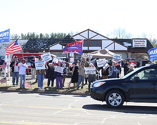 Supporters of President Donald Trump hold flags and signs at the Summitville Tile parking lot on 224, Saturday, March 4, 2017 in Boardman. ..(Nikos Frazier | The Vindicator)..