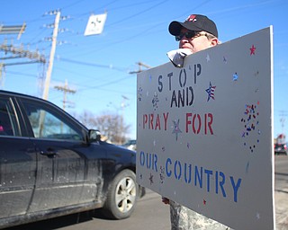 Tom Pressly of Poland holds a "stop and pray for our country" sign as he and others show their support for President Donald Trump at the Summitville Tile parking lot on 224, Saturday, March 4, 2017 in Boardman. ..(Nikos Frazier | The Vindicator)..