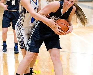 03-04-17 -Lady Basketball-  2nd. qtr., Jackson-Milton's #12 Kaithyn Totani ties up McDonald's #12 Sam Homa.  McDonald Devils vs Jackson-Milton Blue Jays at Mineral Ridge High School in Mineral Ridge, OH.