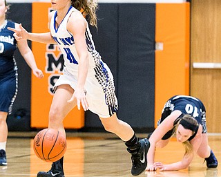 03-04-17 -Lady Basketball-  4th. qtr., Jackson-Milton's #11 Ashley Totani dribbles away from the fallen McDonald's #10 Kendra Kelly.  McDonald Devils vs Jackson-Milton Blue Jays at Mineral Ridge High School in Mineral Ridge, OH.