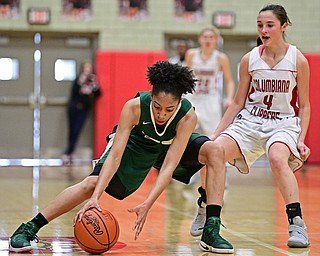 STRUTHERS, OHIO - MARCH 4, 2017: Simone Comer #32 of Ursuline picks up the ball after having it poked out of her control by Kayla Muslovski #4 of Columbiana during the first half of their game Saturday afternoon at Struthers High School. DAVID DERMER | THE VINDICATOR