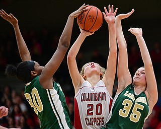 STRUTHERS, OHIO - MARCH 4, 2017: Alexis Cross #20 of Columbiana has her shot blocked by Anyah Curd #30 of Ursuline while being pressured by Lindsay Bell #35 during the first half of their game Saturday afternoon at Struthers High School. DAVID DERMER | THE VINDICATOR
