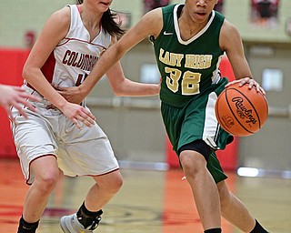 STRUTHERS, OHIO - MARCH 4, 2017: Simone Comer #32 of Ursuline drives on Kayla Muslovski #4 of Columbiana during the second half of their game Saturday afternoon at Struthers High School. DAVID DERMER | THE VINDICATOR