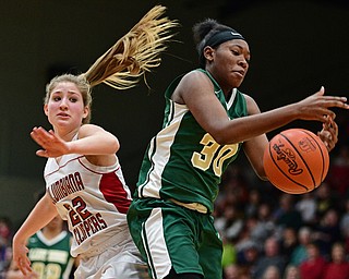 STRUTHERS, OHIO - MARCH 4, 2017: Anyah Curd #30 of Ursuline bobbles the ball while trying to come down with the rebound while being pressured by Brittany Mook #22 of Columbiana during the second half of their game Saturday afternoon at Struthers High School. DAVID DERMER | THE VINDICATOR