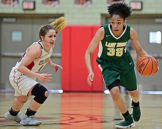 STRUTHERS, OHIO - MARCH 4, 2017: Simone Comer #32 of Ursuline dribbles past Mariah Rovnak #13 of Columbiana during the second half of their game Saturday afternoon at Struthers High School. DAVID DERMER | THE VINDICATOR
