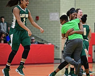 STRUTHERS, OHIO - MARCH 4, 2017: Dayshanette Harris #1 of Ursuline leaps in the air while Anyah Curd gets a hug from her brother, Ahmad Curd, after the final buzzer of their game Saturday afternoon at Struthers High School. DAVID DERMER | THE VINDICATOR
