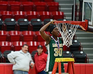 STRUTHERS, OHIO - MARCH 4, 2017: Anyah Curd #30 of Ursuline concentrates on cutting down the net during the celebration, Saturday afternoon at Struthers High School. DAVID DERMER | THE VINDICATOR