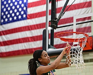 STRUTHERS, OHIO - MARCH 4, 2017: Dayshanette Harris #1 of Ursuline concentrates on cutting down the net during the celebration, Saturday afternoon at Struthers High School. DAVID DERMER | THE VINDICATOR