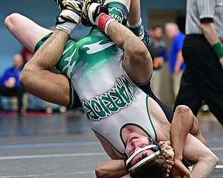 ALLIANCE, OHIO - MARCH 4, 2017: Dylan Miller of West Branch hangs onto Kevon Freeman of Mentor Lake Catholic as he is flipped over during their 145lb championship bout Saturday night at Alliance High School. DAVID DERMER | THE VINDICATOR