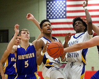 William D. Lewis the Vindicator  Valley's Jordan Trowers(12) shoots past Souther's Jacob Joiner(5). At right is Valley's Emmanuel Armour90).