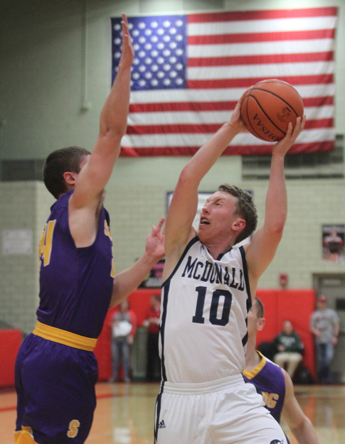 William D Lewis The Vindicator McDonald's Evan Magill(10) shoots over Sebring's Jarod Hunter(24).