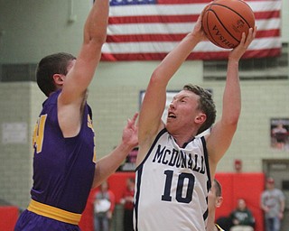 William D Lewis The Vindicator McDonald's Evan Magill(10) shoots over Sebring's Jarod Hunter(24).
