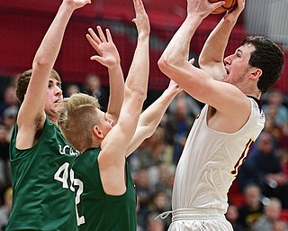 SALEM, OHIO - MARCH 7, 2017: Dan Ritter #11 of South Range puts up a shot over Brian Shepard #40 and Cameron Creamer #2 of Canton Central Catholic during the first half of their game Tuesday night at Salem High School. DAVID DERMER | THE VINDICATOR