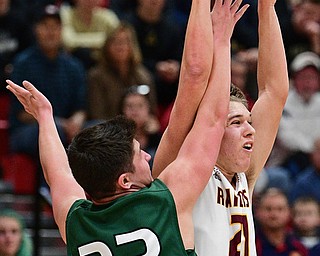 SALEM, OHIO - MARCH 7, 2017: Brandon Youngs #21 of South Range is pressured by Stone Sirpilla #33 of Canton Central Catholic while passing the ball during the first half of their game Tuesday night at Salem High School. DAVID DERMER | THE VINDICATOR