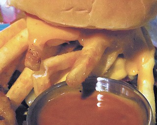 The Kickin Burger at Lanai is built with Pepper Jack and American Cheese sauce, bacon, hot peppers, hot fries, lettuce, tomato, and Cajun ranch on the side. 