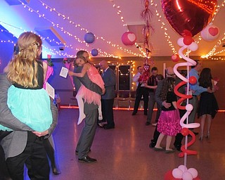 Neighbors | Alexis Bartolomucci.Fathers slow danced with their daughters after the rose ceremony during the Father Daughter Dance at Boardman Park on Feb. 16.