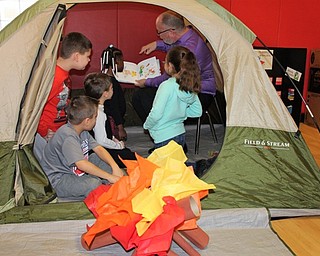 Neighbors | Submitted.Mr. Lenton read to the students by the "campfire" on Feb. 16.