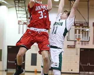 Austin O'Hara(33) of Girard goes up for a layup as Trace Leanard(11) of Ursuline tries to block his shot during the 1st quarter as Girard takes on Ursuline, Thursday, March 9, 2017 at Boardman High School. Ursuline won 62-53...(Nikos Frazier | The Vindicator)..