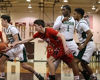 Vince Venzio(22) of Ursuline snatches the ball from Brandon Bowman(23) of Girard during the 1st quarter as Girard takes on Ursuline, Thursday, March 9, 2017 at Boardman High School. Ursuline won 62-53...(Nikos Frazier | The Vindicator)..