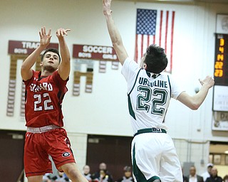 Anthony Graziano(22) of Girard goes up for three as Vince Venzio(22) of Ursuline tries to block his shot during the 1st quarter as Girard takes on Ursuline, Thursday, March 9, 2017 at Boardman High School. Ursuline won 62-53...(Nikos Frazier | The Vindicator)..