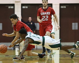 Dakota Hobbs(14) of Ursuline dives for a loose ball from Austin Clausell(2) of Girard during the 2nd quarter as Girard takes on Ursuline, Thursday, March 9, 2017 at Boardman High School. Ursuline won 62-53...(Nikos Frazier | The Vindicator)..