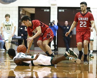 Dakota Hobbs(14) of Ursuline dives for a loose ball from Austin Clausell(2) of Girard during the 2nd quarter as Girard takes on Ursuline, Thursday, March 9, 2017 at Boardman High School. Ursuline won 62-53...(Nikos Frazier | The Vindicator)..